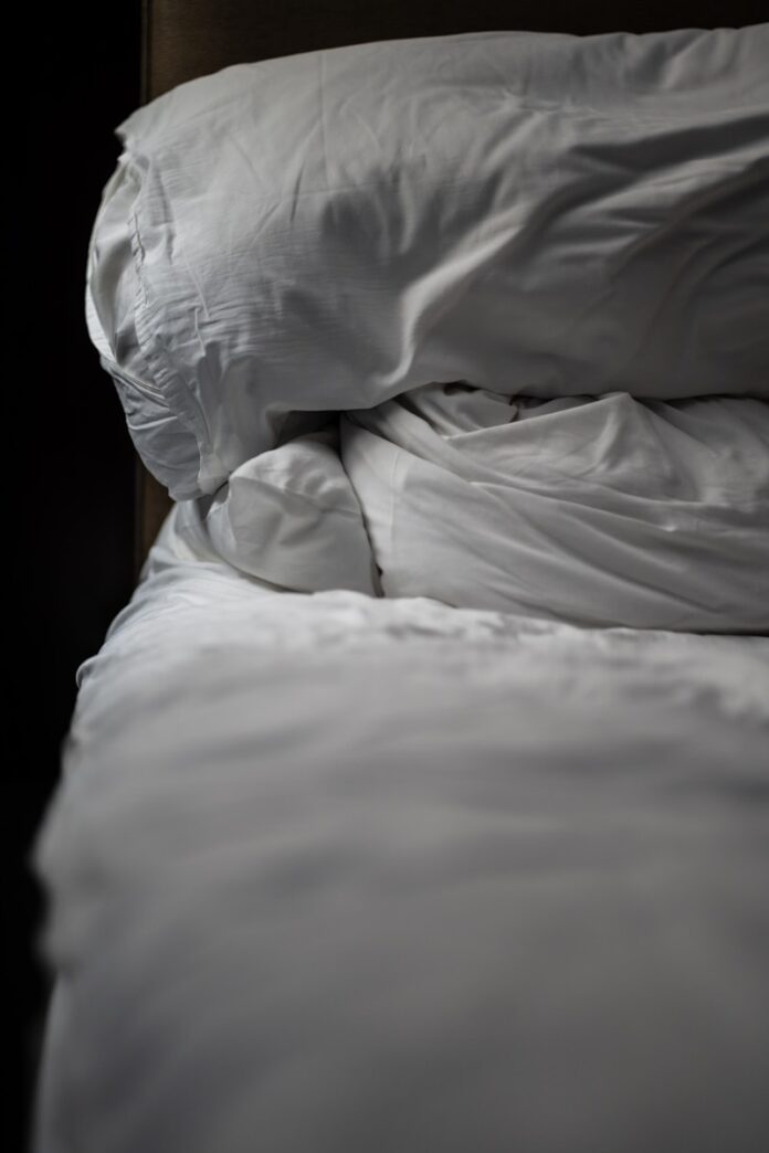 a white pillow on a bed
