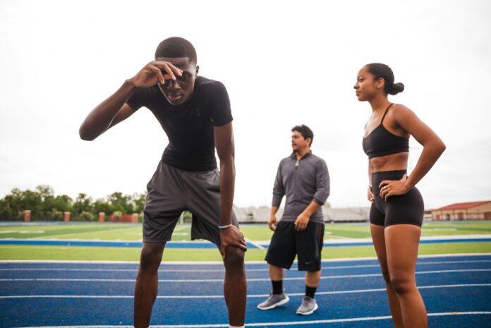 Photo by Land O'Lakes, Inc. Athletes resting on a track after training.