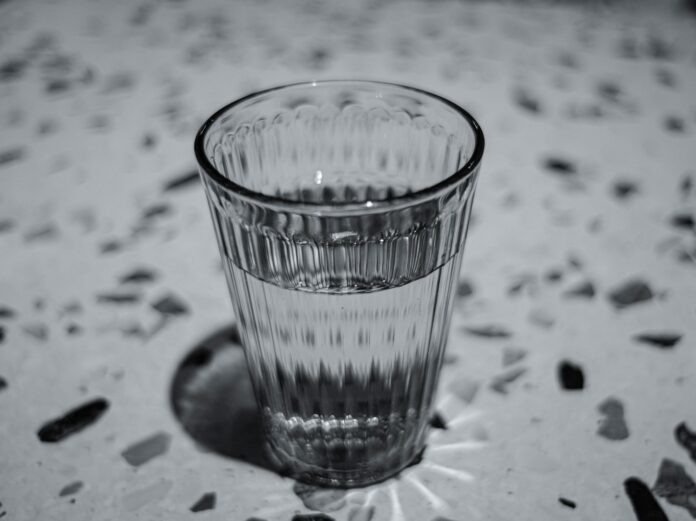 Photo by Cici Hung clear drinking glass on white and black textile