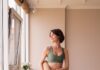 필라테스, 내 몸과 마음을 돌보는 건강한 일상의 선택 a woman in a green sports bra top and leggings holding a yoga mat