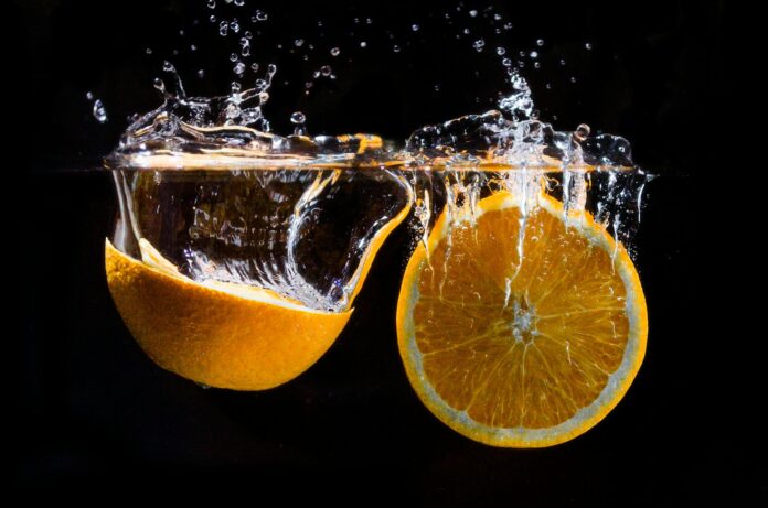 Photo by Koen Emmers orange fruit in water with water