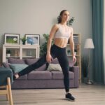 증가하는 홈 트레이닝 열풍, 집에서 건강 지키는 똑똑한 방법 a woman in a sports bra top and leggings in a living room